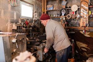 Elderly Craftsman Working in a Rustic Workshop photo