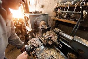 Elderly Craftsman Working in a Rustic Workshop photo