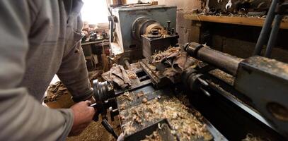 Elderly Craftsman Working in a Rustic Workshop photo