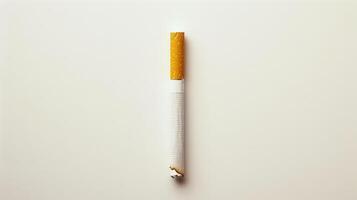 A cigarette is lit and has a red tip. photo