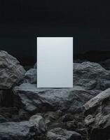 mockup of an A4 paper standing on top of rocks at night, a white blank poster, minimalistic. photo