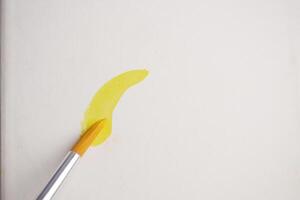 Creating a vibrant yellow stroke on a blank canvas photo