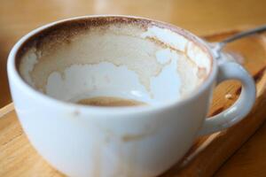 Coffee cup with remnants after enjoying a warm beverage in a cafe photo