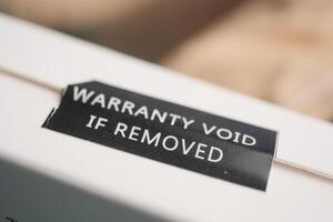 Warranty label indicating void status for removal of seal photo
