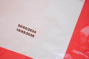 Dates printed on a document in red outline with white background photo