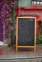 Chalkboard menu at a colorful outdoor cafe in a vibrant neighborhood photo