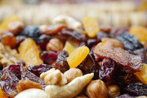 Dried fruits and nuts arranged in a colorful display for snacking photo