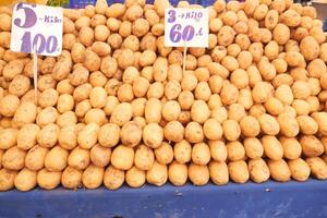 Fresh potatoes displayed at a local market stall photo