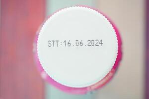 Date stamp on a cap of a beverage container seen from above photo