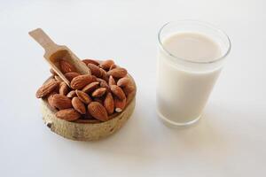 Almonds and almond milk displayed in a rustic setting photo