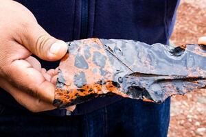 Tourist guide showing a colorful obsidian piece to a group of visitors at the Teotihuacan archeological site. photo