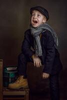 A boy in a suit and scarf is laughing photo