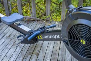 Fort Collins, CO, USA - October 15, 2023, Concept 2 RowErg Rover with PM5 monitor, rowing machine, on a backyard deck. photo