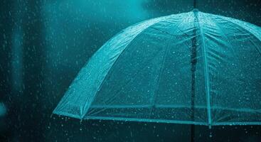 Clear umbrella in heavy rain with water droplets splashing photo