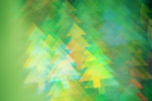 Abstract Festive Light with Christmas Tree Shapes, figured Bokeh as Soft Background, natural flare from lights, blurred texture as winter holidays backdrop, celebration idea with optical effect photo