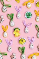 Easter eggs with colored Bunny Ears on Pink Background, minimal Flat lay pattern, Easter holiday concept. Creative Spring festive layout. Top view Diy decorated wooden eggs, pastel colors photo
