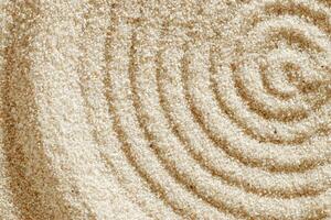 Top view pattern in Japanese Zen Garden with close up concentric circles on sand for meditation, relaxation. Aesthetic minimal sandy background with copy space, beige monochrome neutral tones photo