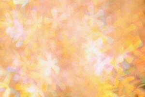 Defocused abstract bokeh background peach trend color, flare from lights, color gradient, blurred figured bokeh as holiday texture. Glittering monochrome aesthetic textured lighting pattern photo