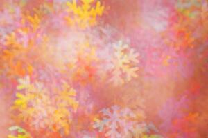Defocused abstract figured bokeh background, glare from lights as snowflakes, blurred snowflake bokeh as winter holiday texture. Creative New Year aesthetic textured lighting pattern for festive photo