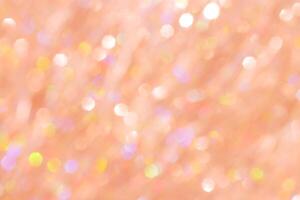 Abstract bokeh background peach colored, natural glare from lights, trend color year 2024 peach fuzz monochrome photo, gradient color, blurred texture as Glittering aesthetic textured pattern photo
