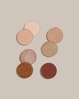 Pattern with eye shadow beige brown natural color on neutral colored background. Makeup palette, set of swatches eyeshadows powder, shine and matte, minimal style, pastel colored, flat lay photo