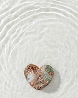 Two natural seashells form heart, sea water gentle ripples cast soft, wavy shadows on clean, light-color background, summer, serene, minimalist aesthetic concept. Feelings of love, tranquil photo