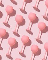 Minimal trend pattern from pink colored wine glasses on pastel pink background, monochrome geometric stylish layout of goblets. Entertainment, event, party concept. Abstract alcohol drinks photo