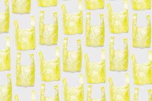 Top view pattern from Yellow plastic bags. Single-use polythene packet, Eco trend to reduce disposable plastics, Biodegradable packaging waste, creative photo pattern as design backgroun