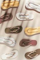 Summer flip flops flat lay, minimal repeat pattern, beach footwear neutral colored, top view still life with womans slide sandals, many shoes, summer beach holiday concept, shadow from sunlight photo