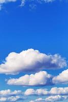 Blue sky with white clouds, bright colored cloudscape. Fluffy heaven pattern, aesthetic natural scene. Beautiful Cloudy background, nature environment backdrop, wallpaper photo
