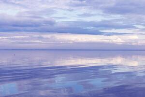 Beautiful white blue clouds over lake, symmetry sky background, cloudscape on lake Ik, Russia. Nature abstract, cloudy sky reflected on water, calm windless weather, natural environment photo