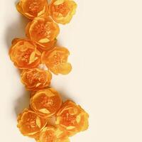 Minimal monochrome flowery background with orange colored delicate wild flowers peony on beige, copyspace, aesthetic floral design top view, natural blooming spring bloom, holiday card, nature photo
