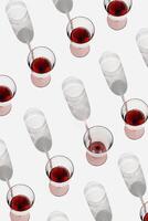 Minimal pattern with glasses of red wine with sunlight shadows, Creative idea summer flat lay with Full Wine glasses and one empty on white, layout alcohol drinks, trend aesthetic photo