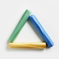 Recycling symbol made from colored disposable plastic bags on white background. Waste reduction, Save planet, eco, recycling concept. Pollution from Polyethylene packets, not use plastic bag photo