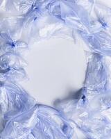 Plastic free environment protection concept. Empty used plastic bags, monochrome frame background, copy space. Aesthetic top view blue disposable polyethylene packet. Plastic bag free day photo