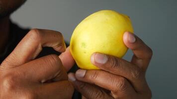 Squeezing a lemon with hands to extract fresh juice video