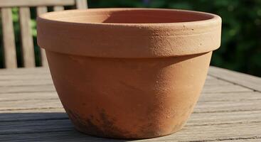 A Detailed Closeup of an Empty Terracotta Flower Pot on a Wooden Table photo