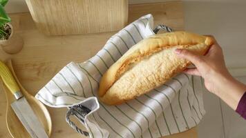 Freshly baked bread on a wooden table with kitchen tools video