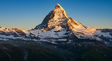 Majestic Mountain Peak Under Sunlight Sky and Snow Covered Landscape photo