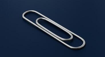 A Detailed CloseUp of a Large Elegant Silver Paperclip on a Deep Blue Background photo