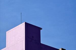 Lightning Rod on Minimal Old Building with Blue Sky Background. photo