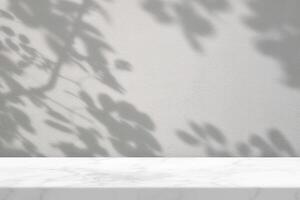 Empty Marble Table with Tree Shadow on Concrete Wall Texture Background photo