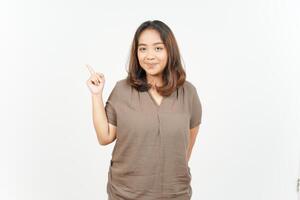 Asian woman pointing finger up on white background photo