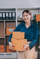 A woman holding a stack of boxes in an office photo