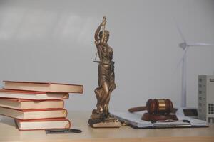 A statue of justice is sitting on top of a desk photo