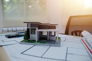 A model of a house sitting on top of a desk photo