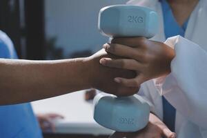 A doctor holding a dumbbell in front of another person photo