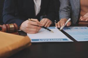 Two business people are signing papers and writing on a document photo