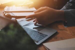 A person is using a laptop on a desk photo