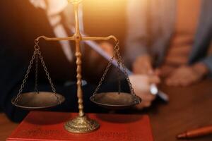 Lawyer and judge in court room with scales of justice photo